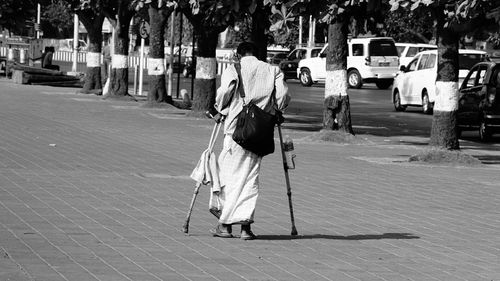 Rear view of woman standing on city street