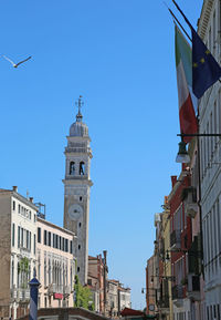 Low angle view of buildings against blue sky