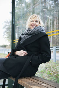 Mature woman on bus stop