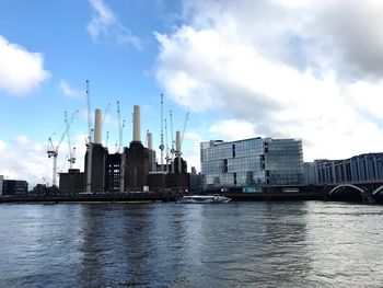 River by buildings against sky in city