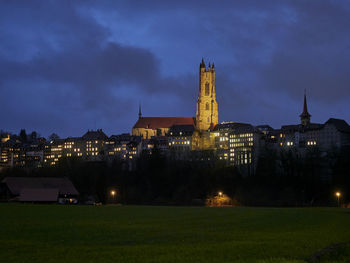 Illuminated buildings against sky at night