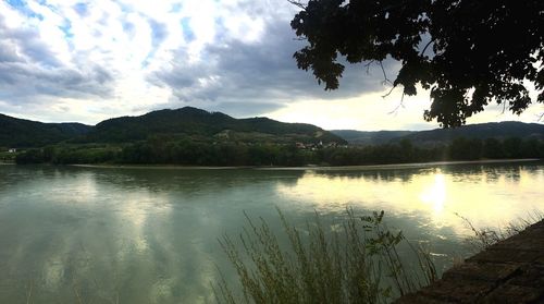 Scenic view of lake and mountains against sky