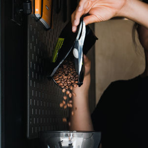 Midsection of person holding coffee cup