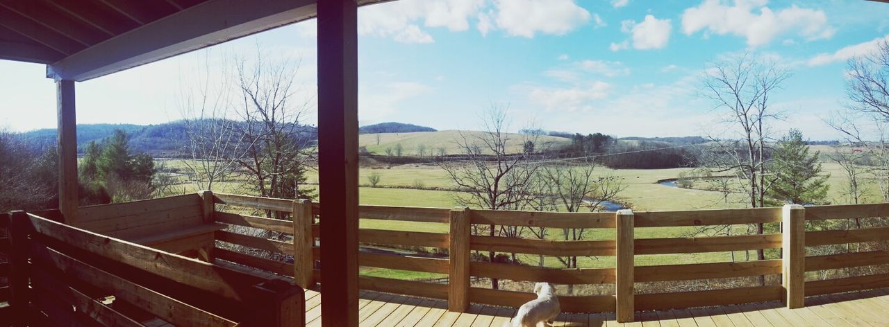 sky, window, tree, built structure, mountain, architecture, house, building exterior, indoors, glass - material, cloud - sky, day, transparent, cloud, sunlight, railing, landscape, roof, nature, no people