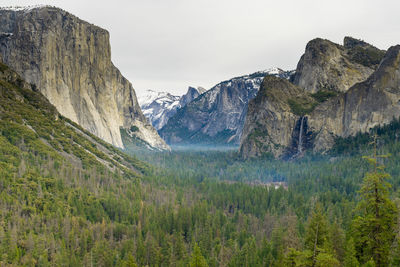Scenic view of land and mountains against sky