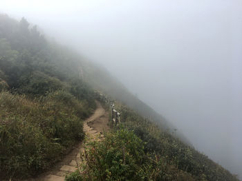 Scenic view of landscape against foggy weather