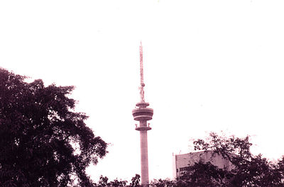 Low angle view of communications tower against sky