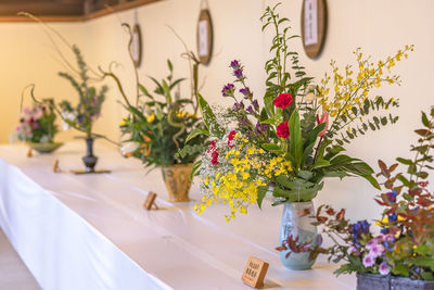 Close-up of flower vase against wall