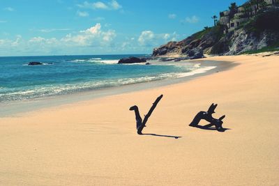 Scenic view of beach against blue sky