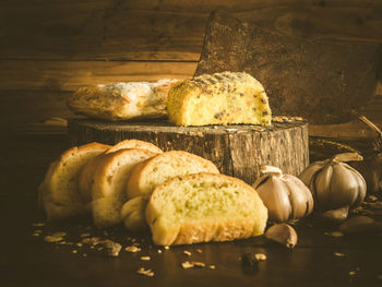 Close-up of breads and garlic on table