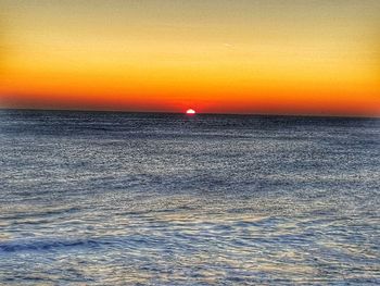 Scenic view of sea against romantic sky at sunset