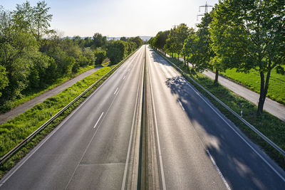 Road amidst trees against sky