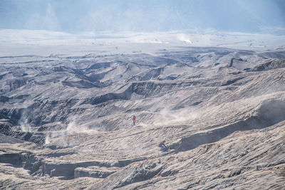 High angle view of people on mountain against sky