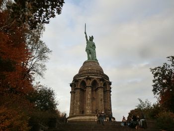 Low angle view of statue against cloudy sky