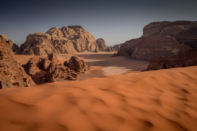 Rock formations in desert against sky