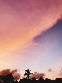 Low angle view of silhouette trees against romantic sky