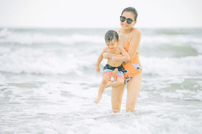 Full length of father and son on beach