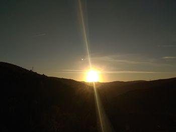 Scenic view of silhouette mountains against sky during sunset