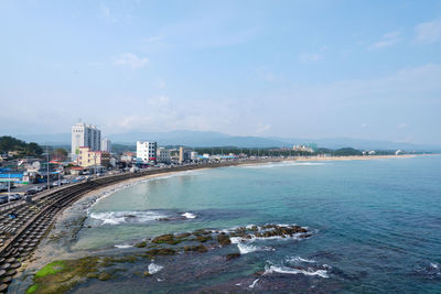 Scenic view of sea and buildings against sky