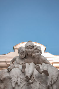 Low angle view of statue against clear blue sky