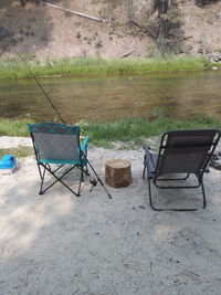 Chairs and table by lake