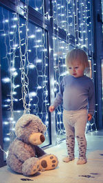 Cute boy with toy standing in toys