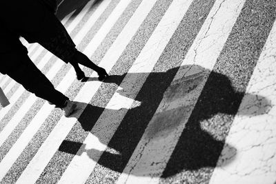 Low section of people standing on tiled floor