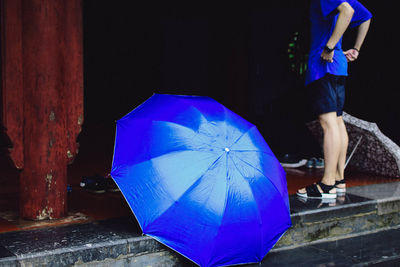 Low section of person with umbrella in rain