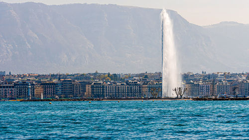 Sea against buildings in city