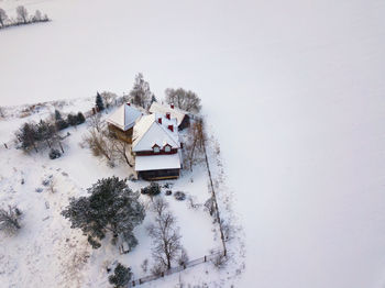 High angle view of snow covered trees on field