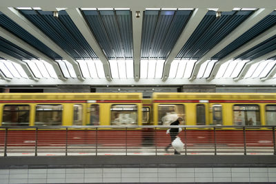 Blurred motion of train standing on railroad station platform