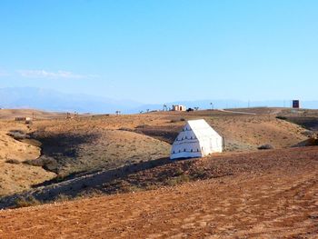 Scenic view of land against clear blue sky