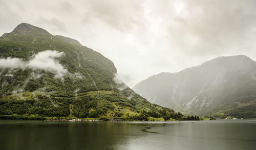 Scenic view of lake and mountains against sky