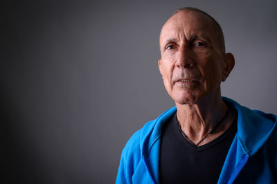 Portrait of man against gray background