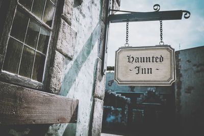 Low angle view of information sign on building