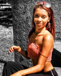 Portrait of a smiling young woman sitting outdoors