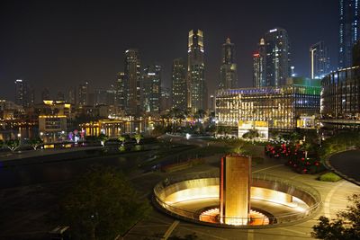 Illuminated modern buildings in city at night