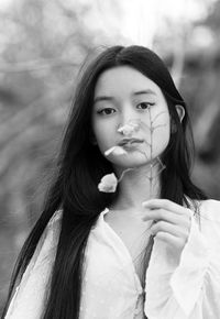 Chinese teenager with a flower in hand iii