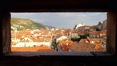 Houses in town against sky