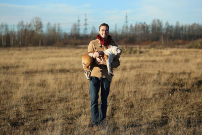 Portrait of young couple standing on field