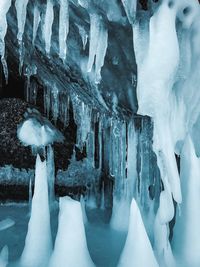 Low section of person standing on frozen ice