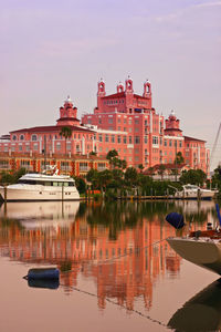 Boats in river with buildings in background