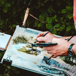 Man painting outdoors 