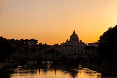 View of buildings against clear sky during sunset