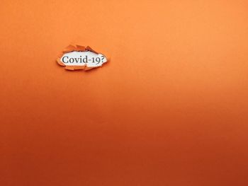 Close-up of text on orange wall