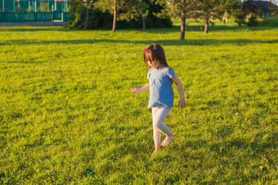 Full length of boy running on field