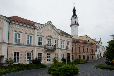 Exterior of historic building by road against sky