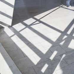 High angle view of shadow on tiled floor