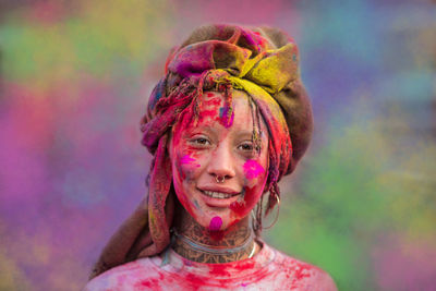 Portrait of smiling young woman with powder paint