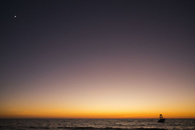 Scenic view of sea against clear sky during sunset